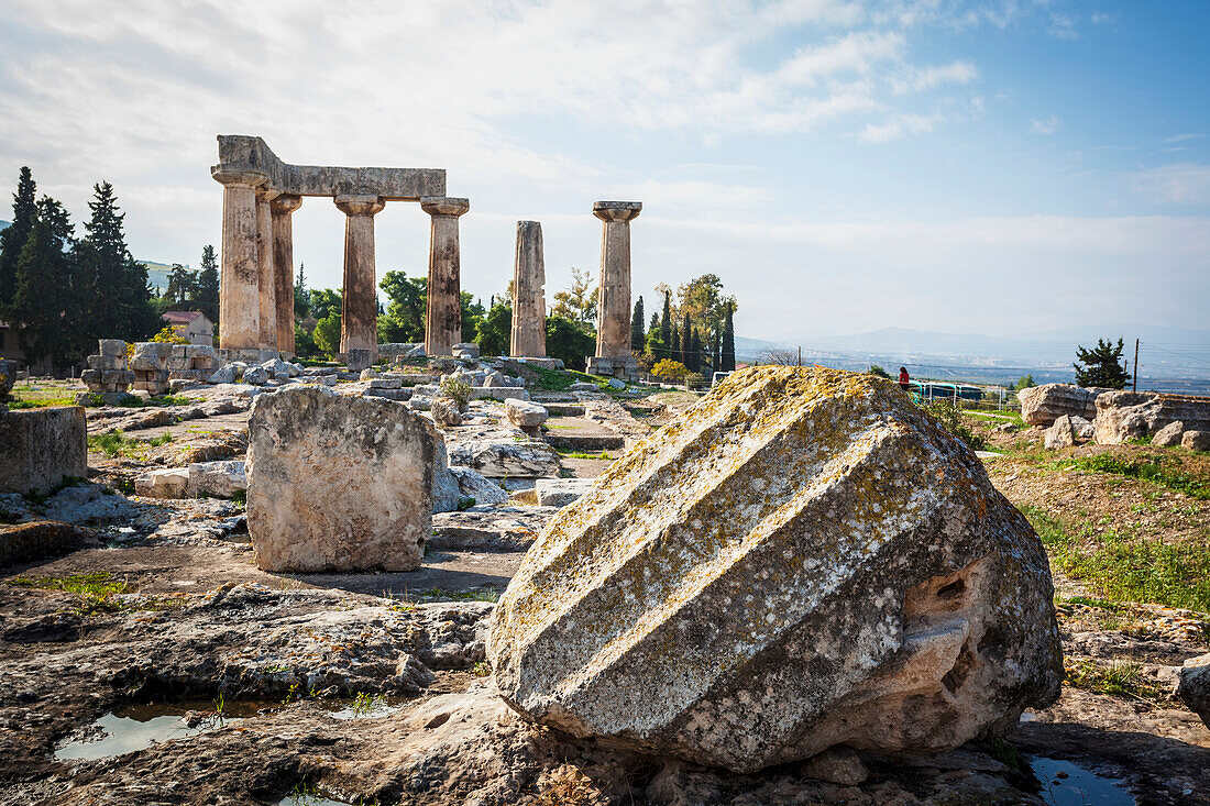 Stone ruins with columns and a boulder, Corinth, Greece