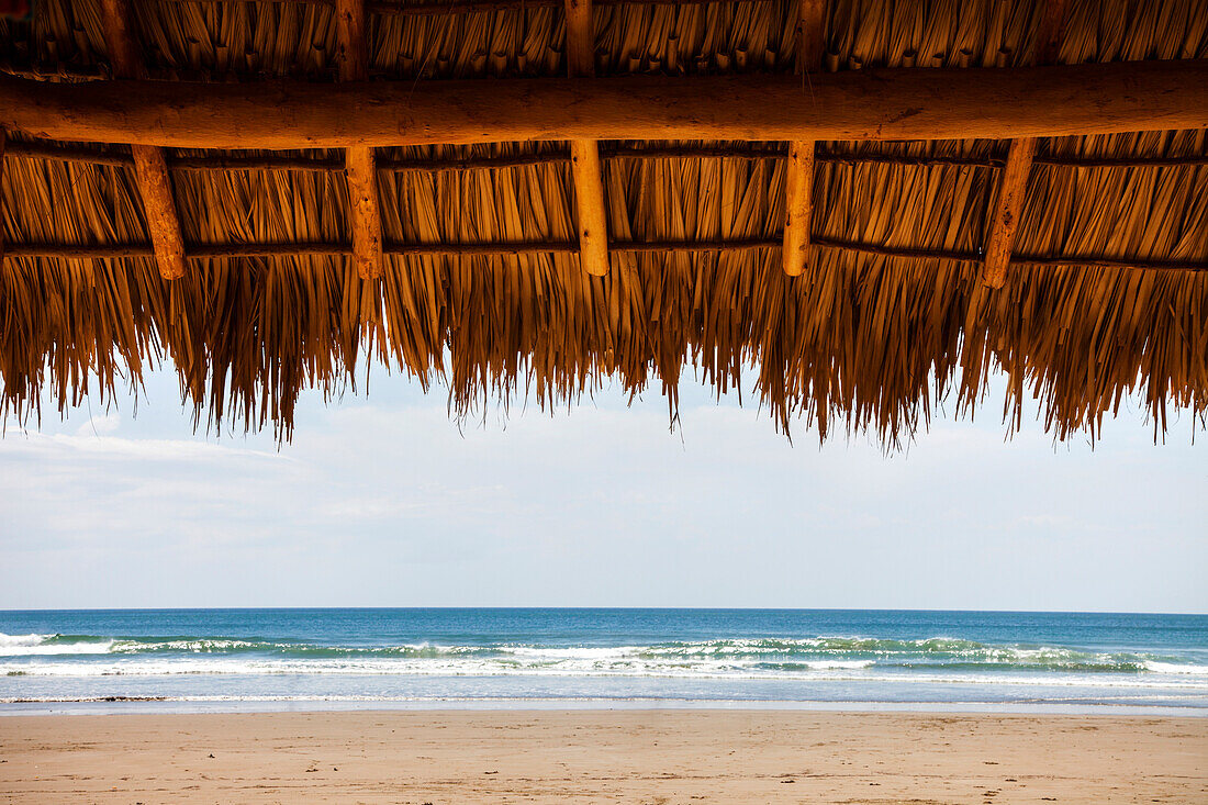 Shaded shelter with straw top in Playa Hermosa, Nicaragua