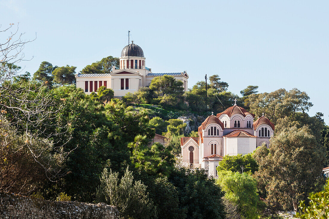 Church buildings on a hill surrounded by trees, Athens, Greece