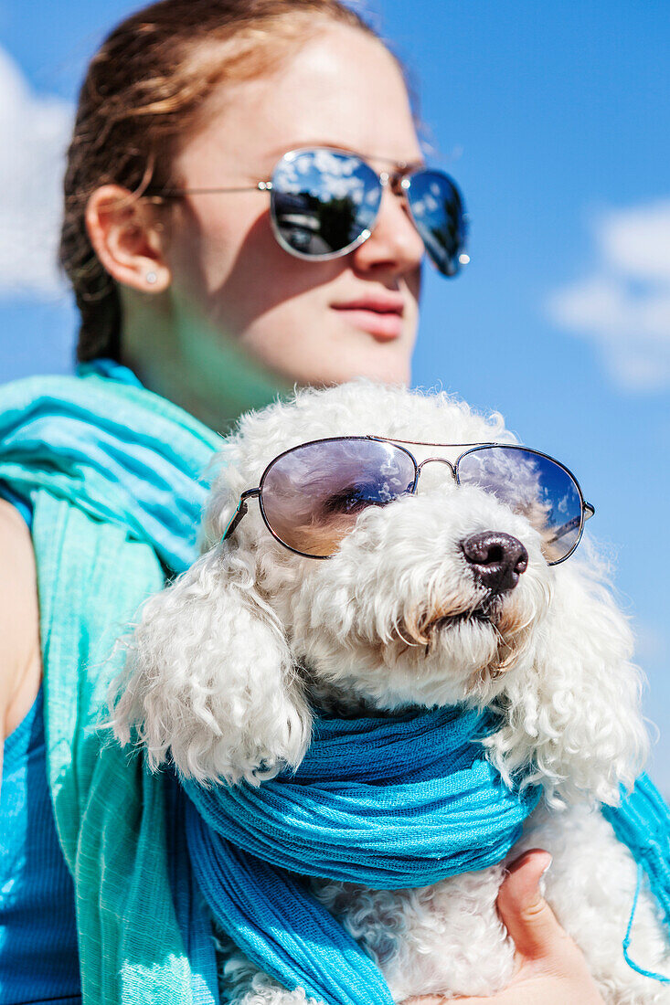 Girl and her dog wearing matching sunglasses, Balsam Lake, Ontario, Canada