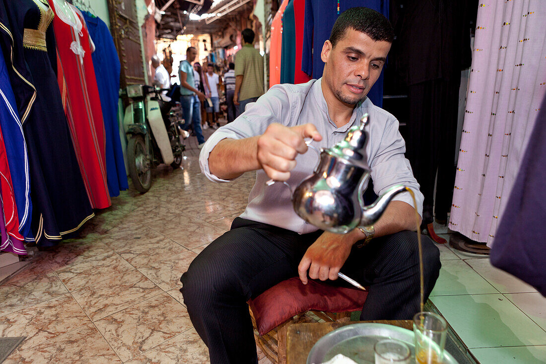 Vendor in the souks pouring tea, Marrakech, Morocco