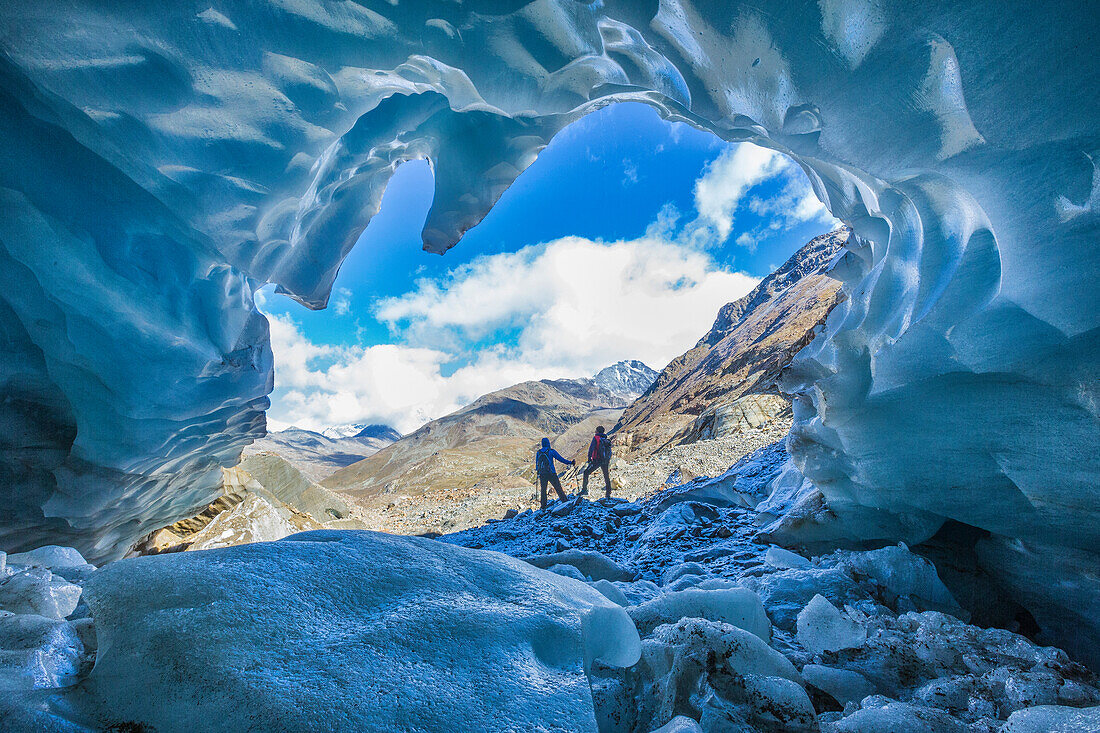 Hikers inside Forni Glacier, Forni Valley, Stelvio National Park, Valtellina, Lombardy, Italy, Europe