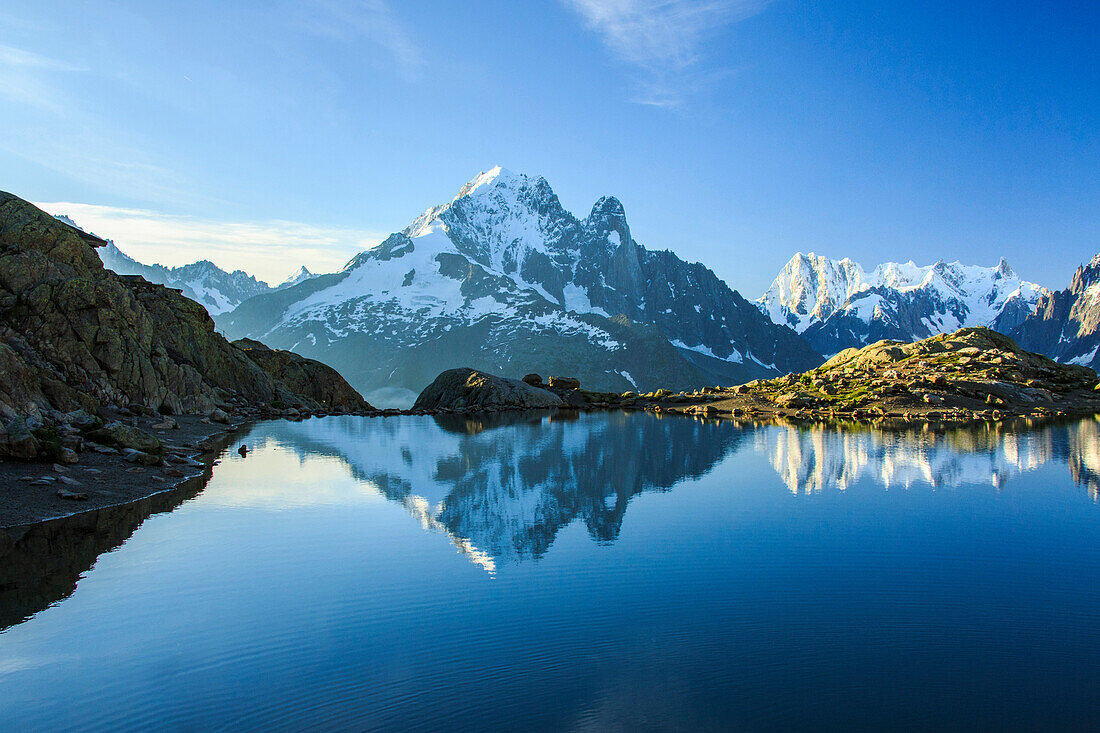 The snowy peaks of Mont Blanc are reflected in the blue water of Lac Blanc at dawn, Chamonix, Haute Savoie, French Alps, France, Europe