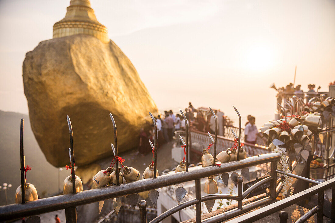 Prayer bells at sunset at Golden Rock Stupa Kyaiktiyo Pagoda, Mon State, Myanmar Burma, Asia