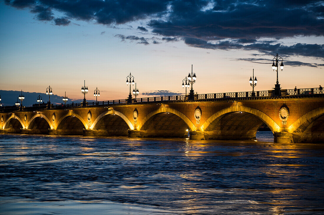 Historic bridge Pont de Pierre over the Garonne River at sunset, Bordeaux, Aquitaine, France, Europe