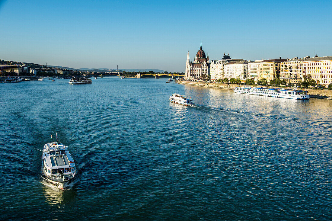Little ferries on the River Danube in front of the Panorama of Pest, Budapest, Hungary, Europe