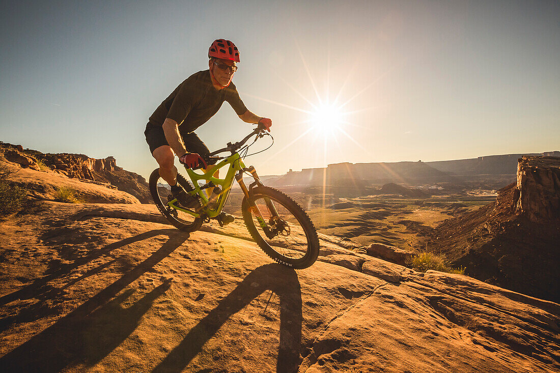 A man mountain biking on the Captian Ahab trail, Moab, Utah.