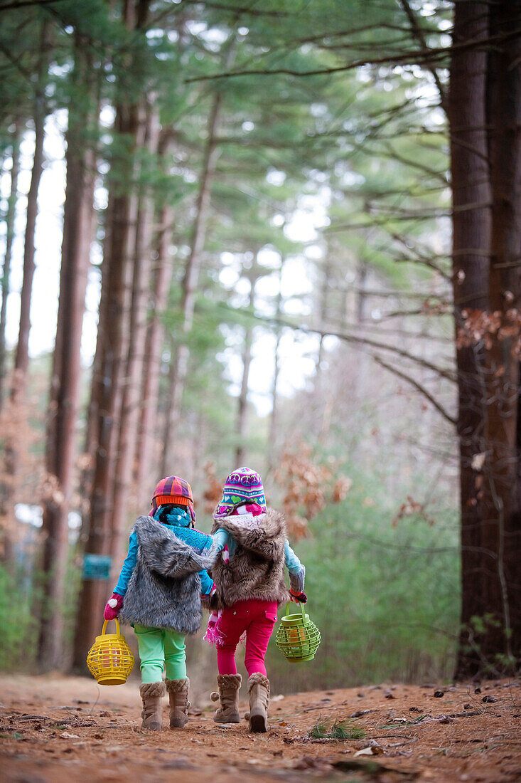 Caucasian girls walking in forest