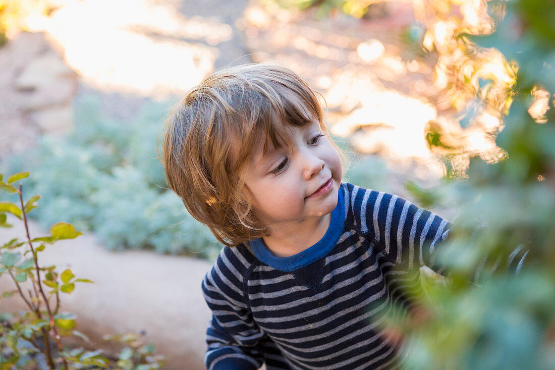 Caucasian boy playing in garden