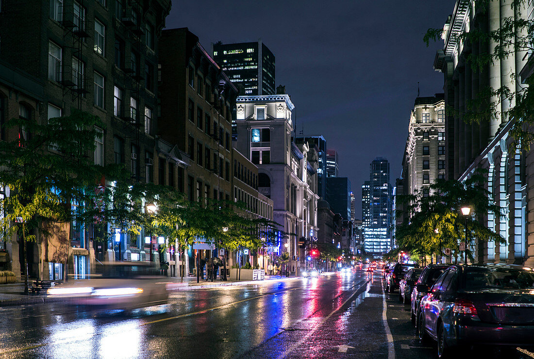 Traffic in wet cityscape at night