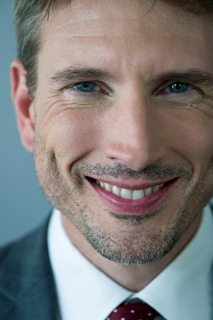 Businessman smiling cheerfully, portrait