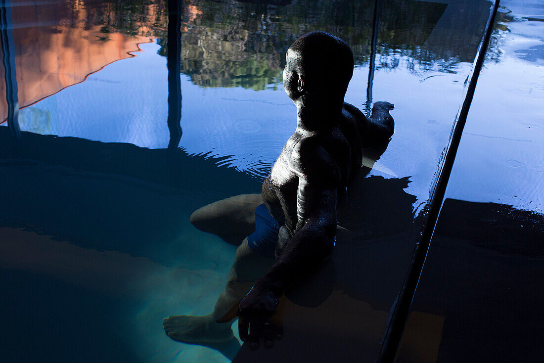 Man relaxing in indoor pool
