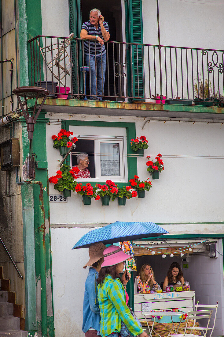 women with umbrellas, la concha bay, monte urgull, san sebastian, donostia, basque country, spain