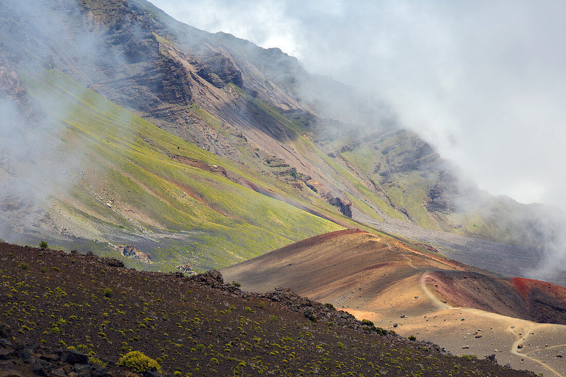 clouds and colors in the haleakala crater, hiking trail on the volcanic rock, maui, hawaii, united states, usa