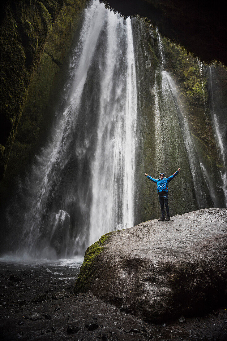 Tourist at the hidden Gljufrabui Waterfall, near Seljalandsfoss, South Iceland Sudurland, Iceland, Polar Regions