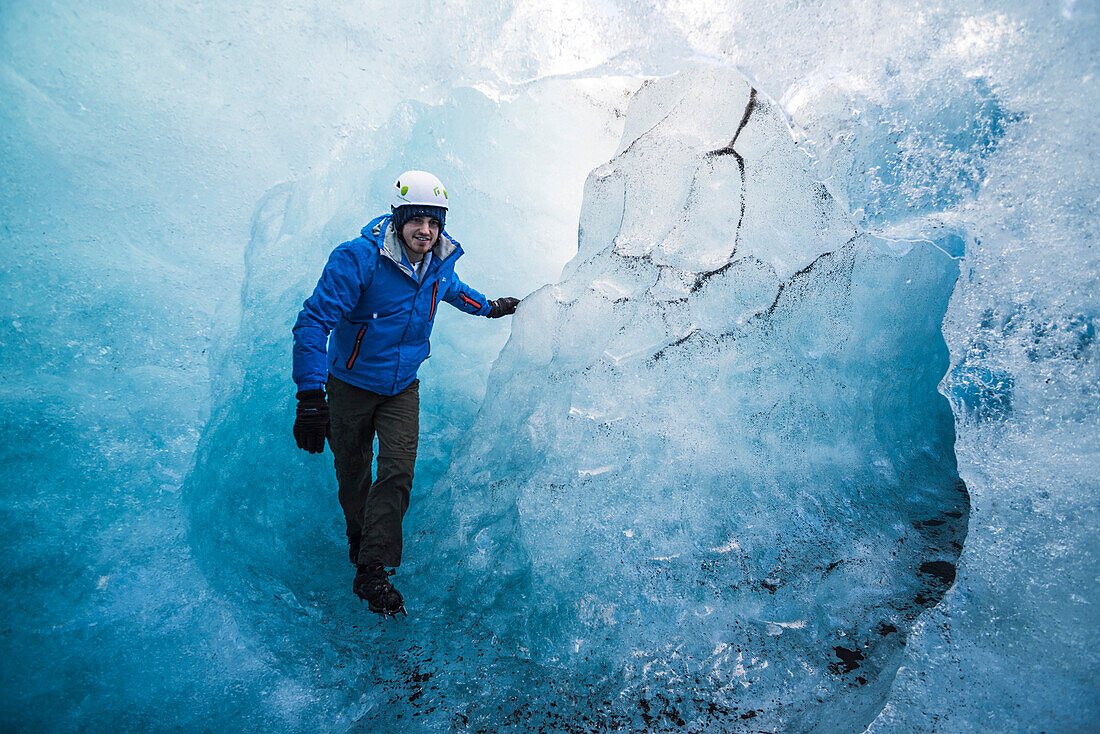 Tourist exploring an ice cave on Breidamerkurjokull Glacier, Vatnajokull Ice Cap, Iceland, Polar Regions