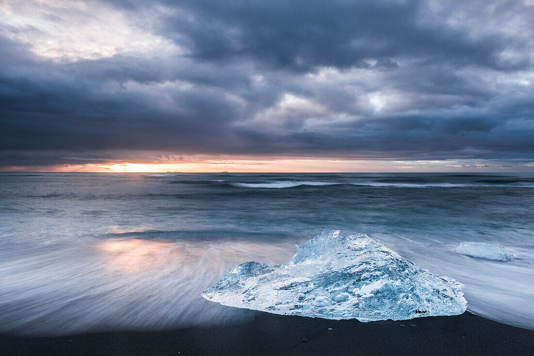Iceberg at sunrise on Jokulsarlon Beach, a black volcanic sand beach in South East Iceland, Iceland, Polar Regions
