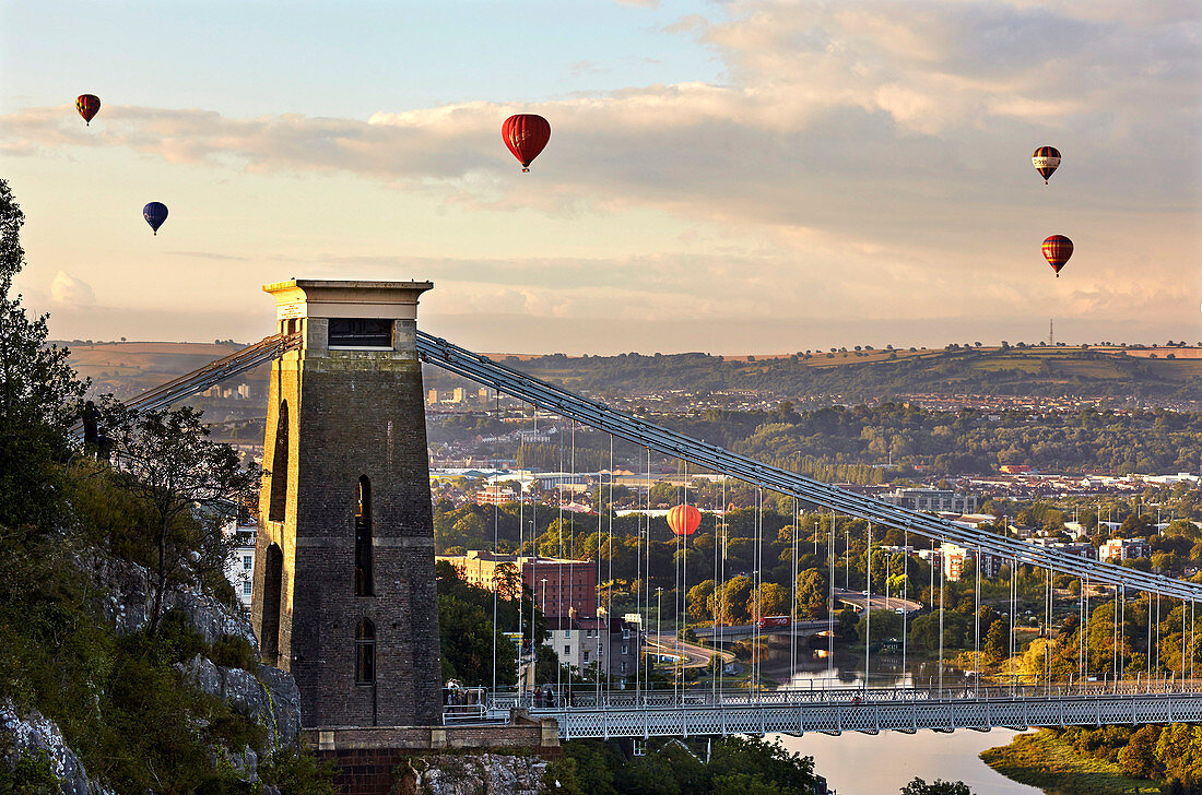 Clifton Suspension Bridge, with hot air balloons in the Bristol Balloon Fiesta in August, Clifton, Bristol, England, United Kingdom, Europe