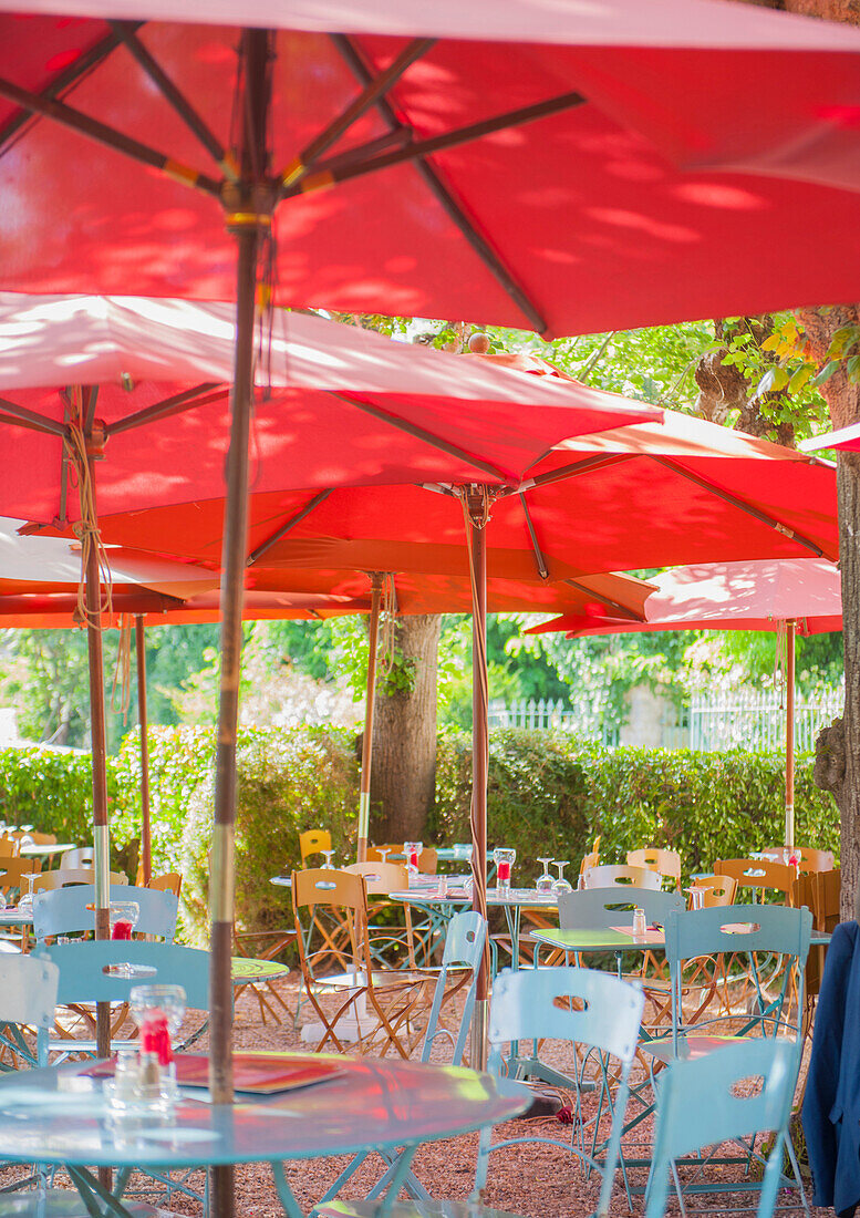 Cafe tables under parasols in rural France, Europe