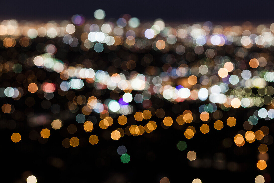 Defocused image of illuminated city at night