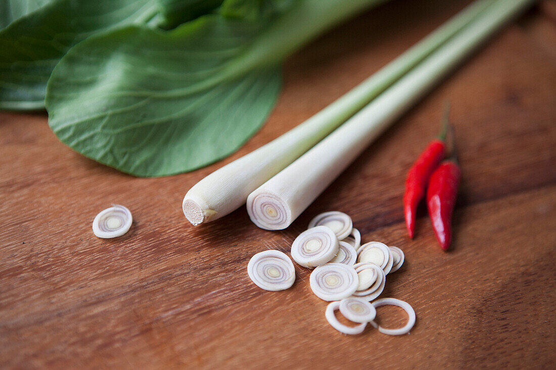 Chopped leek with red chili peppers on wooden table