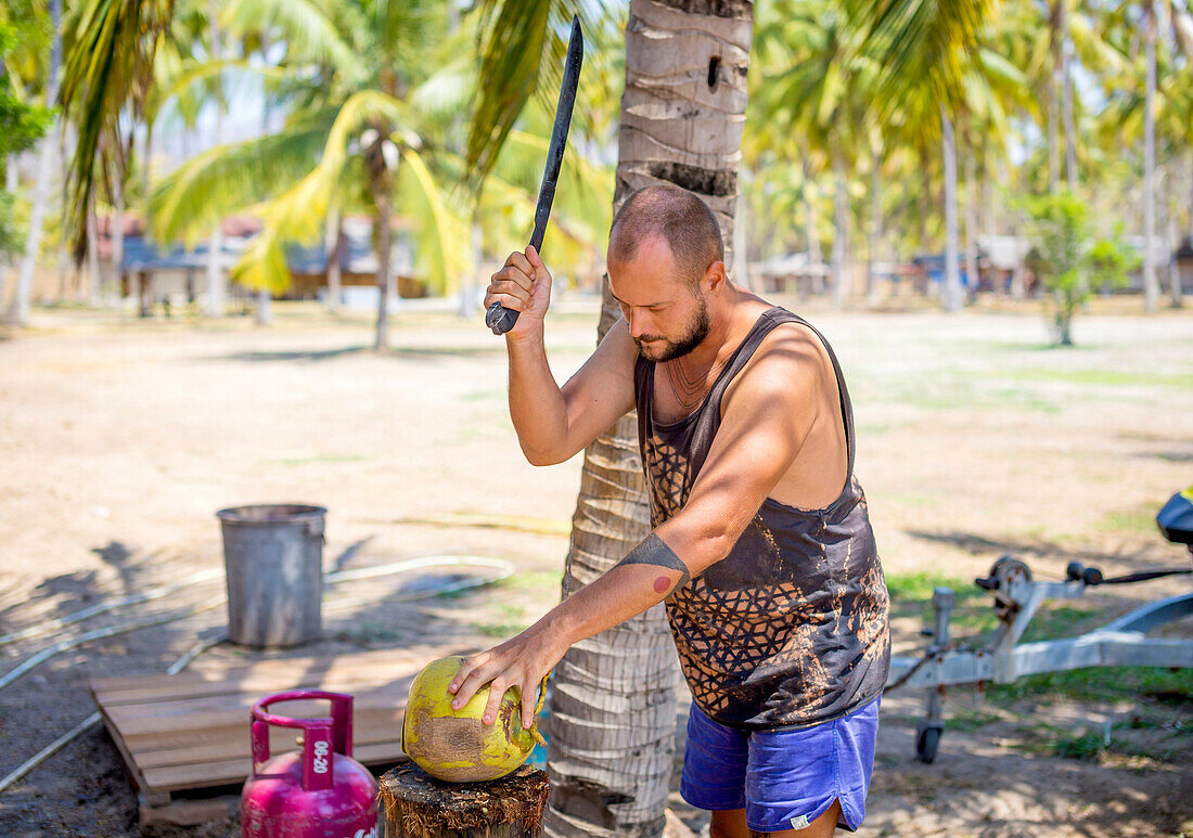 Young man wirh coconut.Sumbawa.Indonesia.