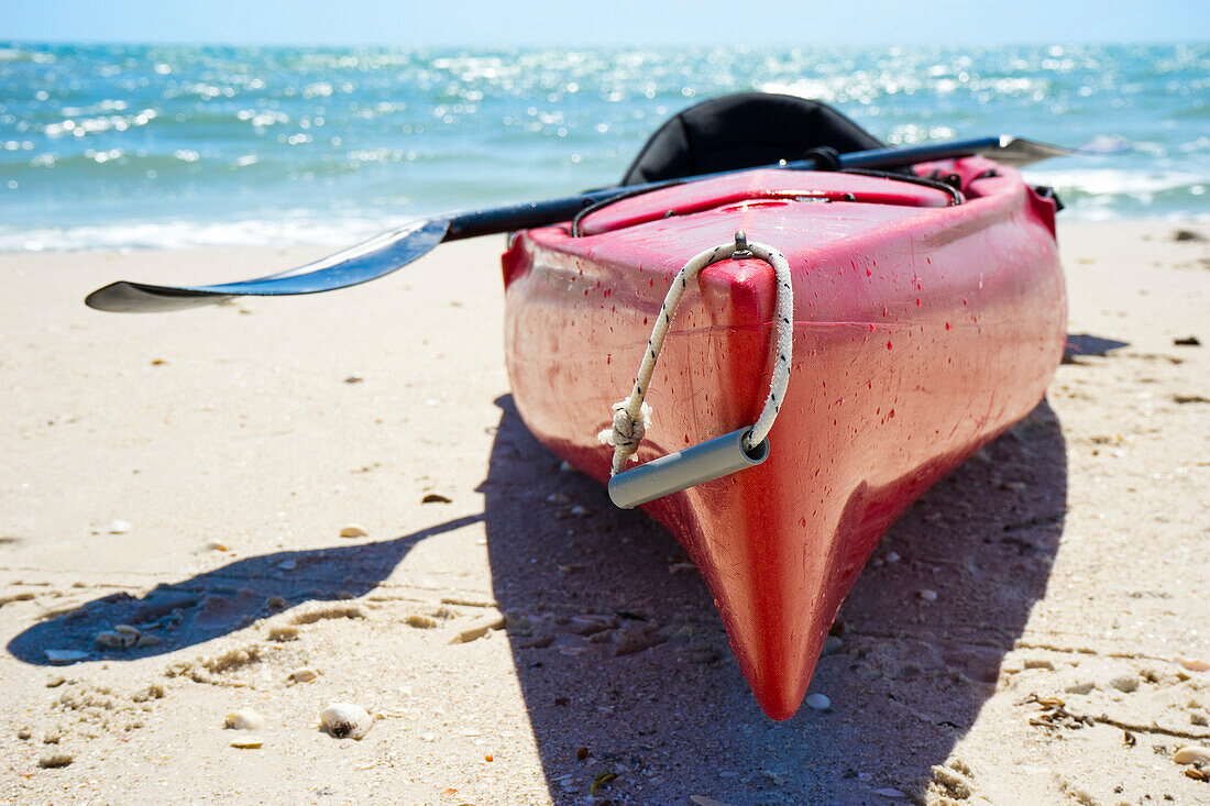 Kayak on the beach with the ocean in the background