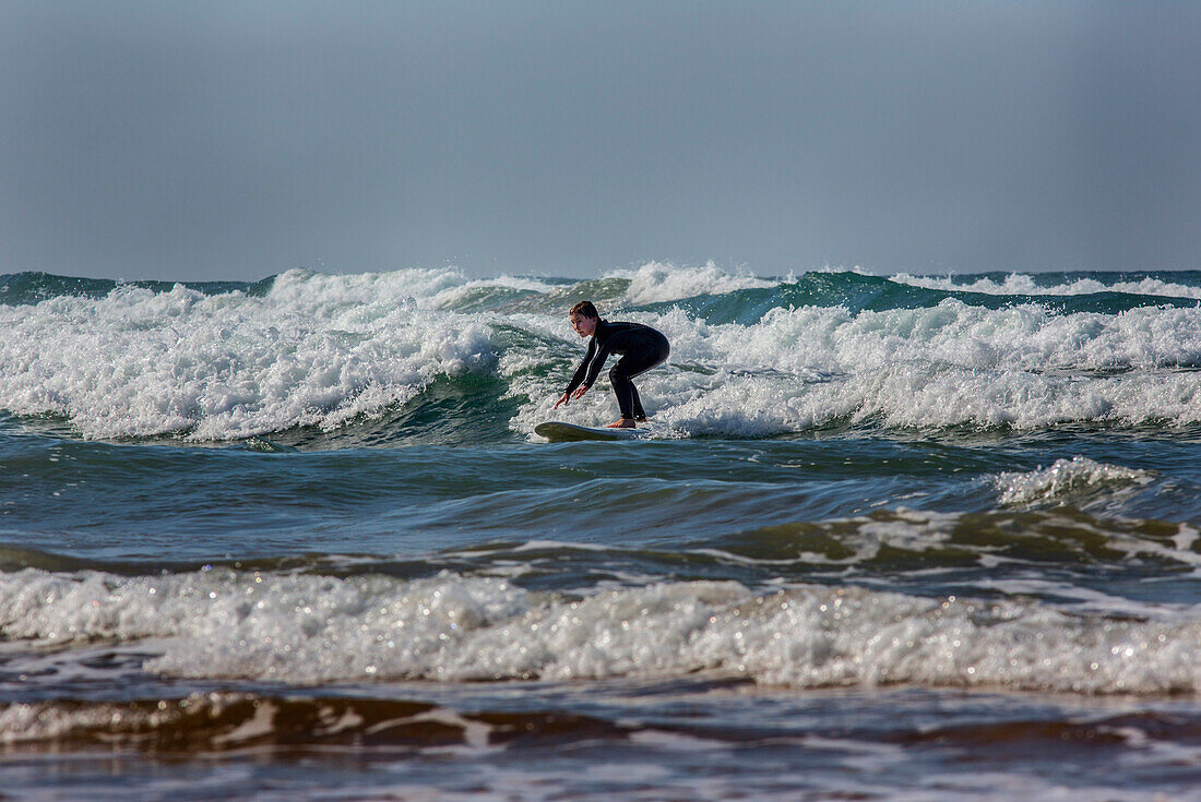 A young boy from Stockholm, Sweden take part of Surf Berberes surfing school in the Atlantic Ocean.