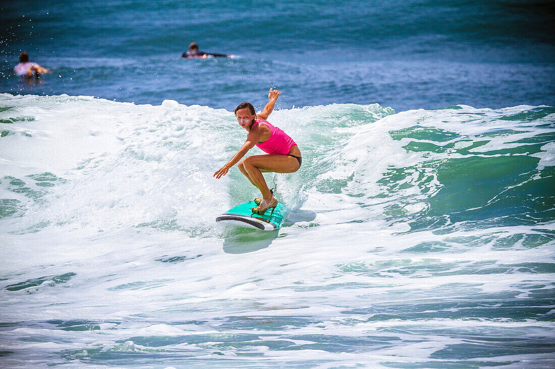 Surfer girl catches wave in high heels.