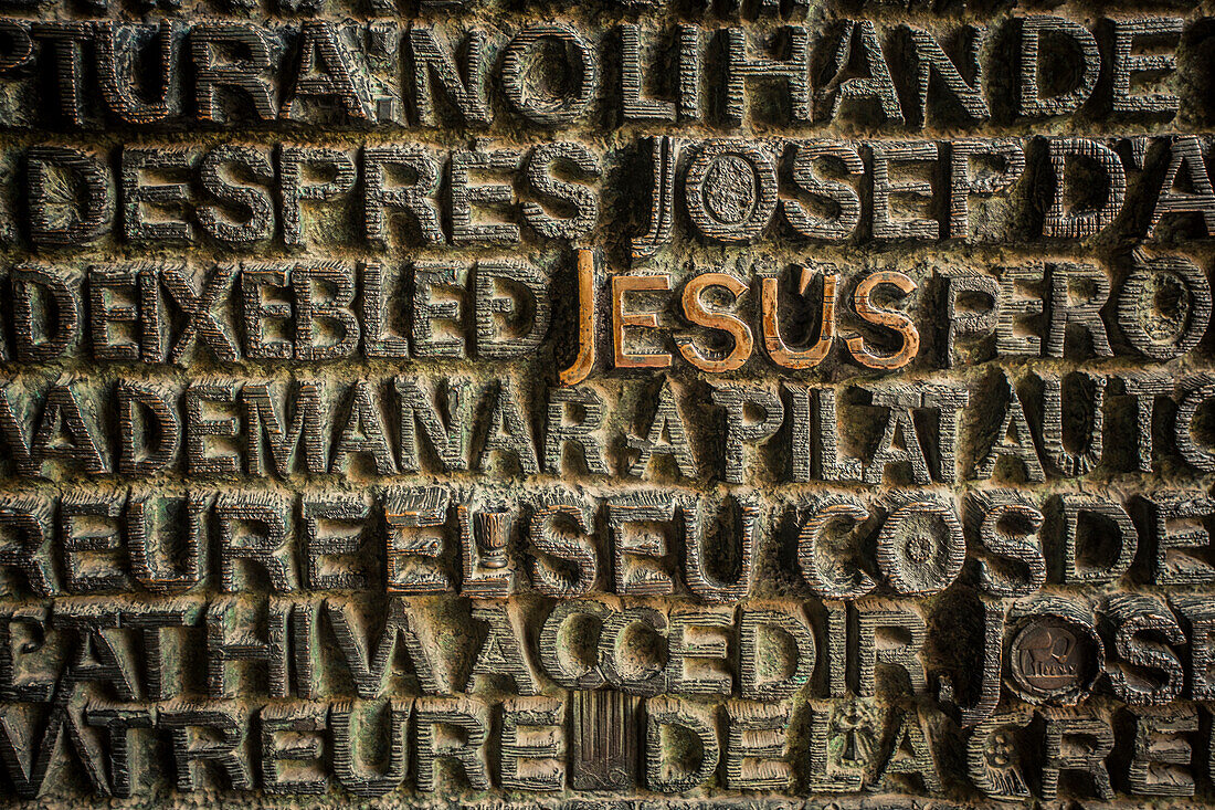 Religious typography on a metal door in Barcelona, Spain.