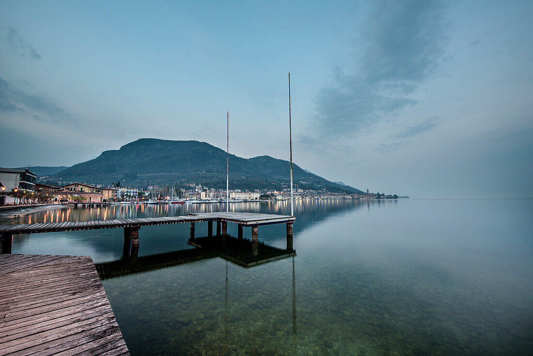 Shoreline of lake Garda at dusk, Salo, Lake Garda, Alps, Lombardy, Italy