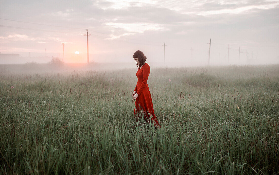 Caucasian woman walking in remote field