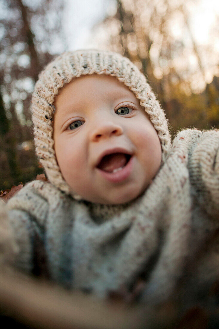Close up of baby boy smiling outdoors