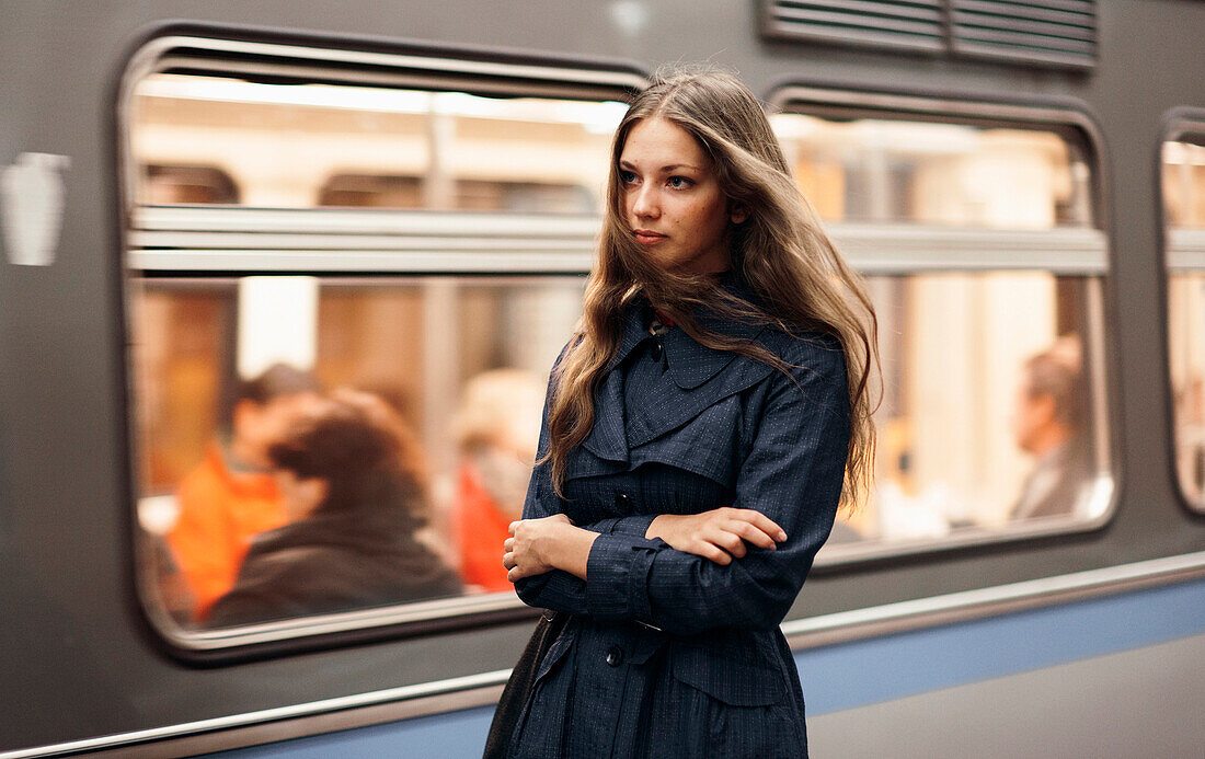 Caucasian woman waiting for subway train