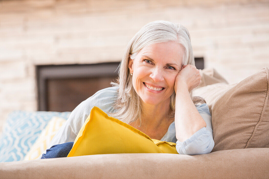 Caucasian woman smiling on sofa