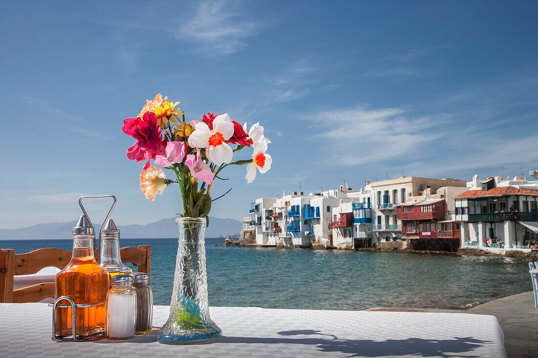 Seasonings and flowers on oceanfront cafe table