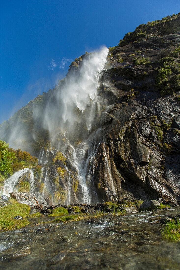 Waterfall pouring over remote cliff