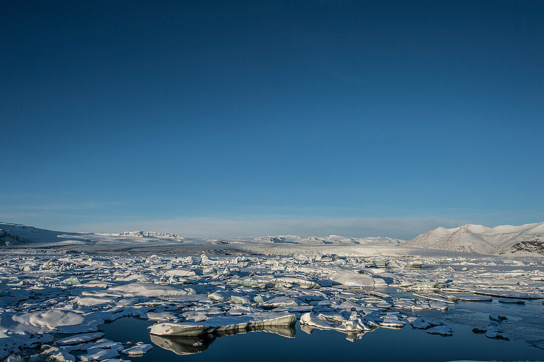 Glacierlagoon with growler, Winter, Snow, Joekulsarlon, Vatnajoekull Glacier, Iceland