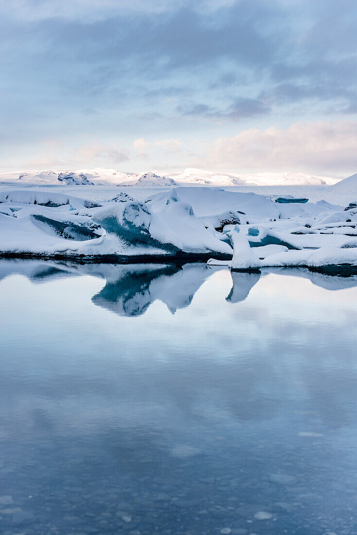 Joekulsarlon with growler at sunset, Glacierlagoon, Vatnajoekull Glacier in Winter, Iceland