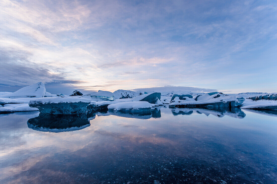 Joekulsarlon with growler at sunset, Glacierlagoon, Vatnajoekull Glacier in Winter, Iceland