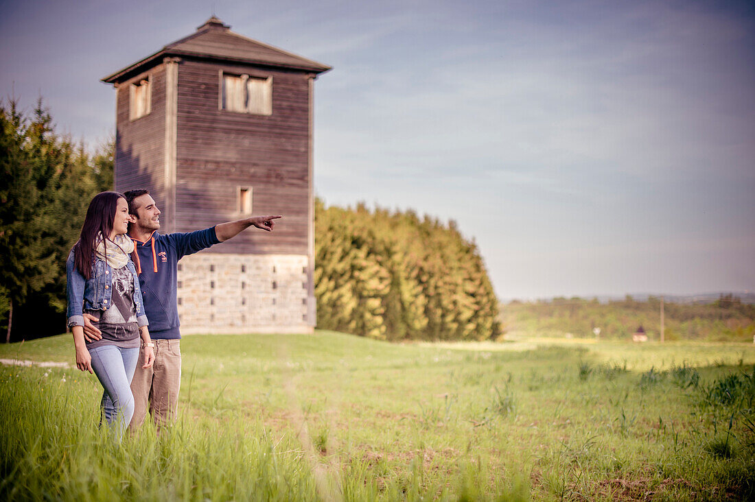 Couple standing in front of the limes tower, limes, Lake Bucher reservoir, Rainau, close to Aalen, Ostalbkreis, Baden-Wuerttemberg, Germany