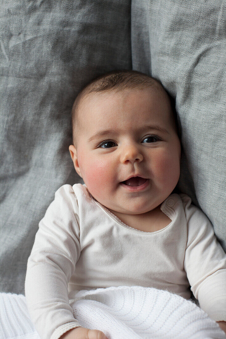 Directly above shot of baby girl lying in bed