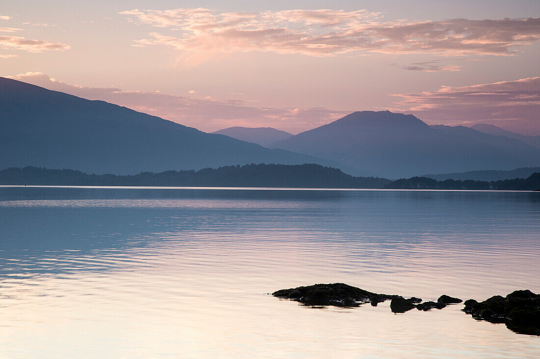 Idyllic view of lake and mountains during sunset