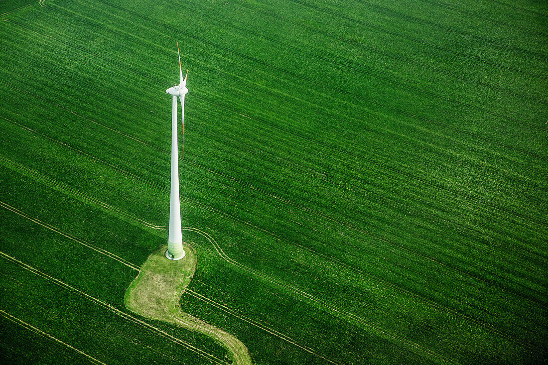 High angle view of wind turbine on green landscape