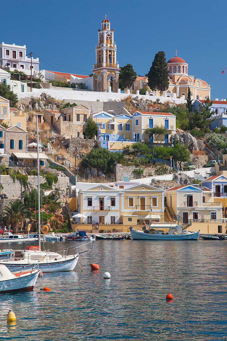 View over harbour to colourful houses and church, Gialos Yialos, Symi Simi, Rhodes, Dodecanese Islands, South Aegean, Greece, Europe
