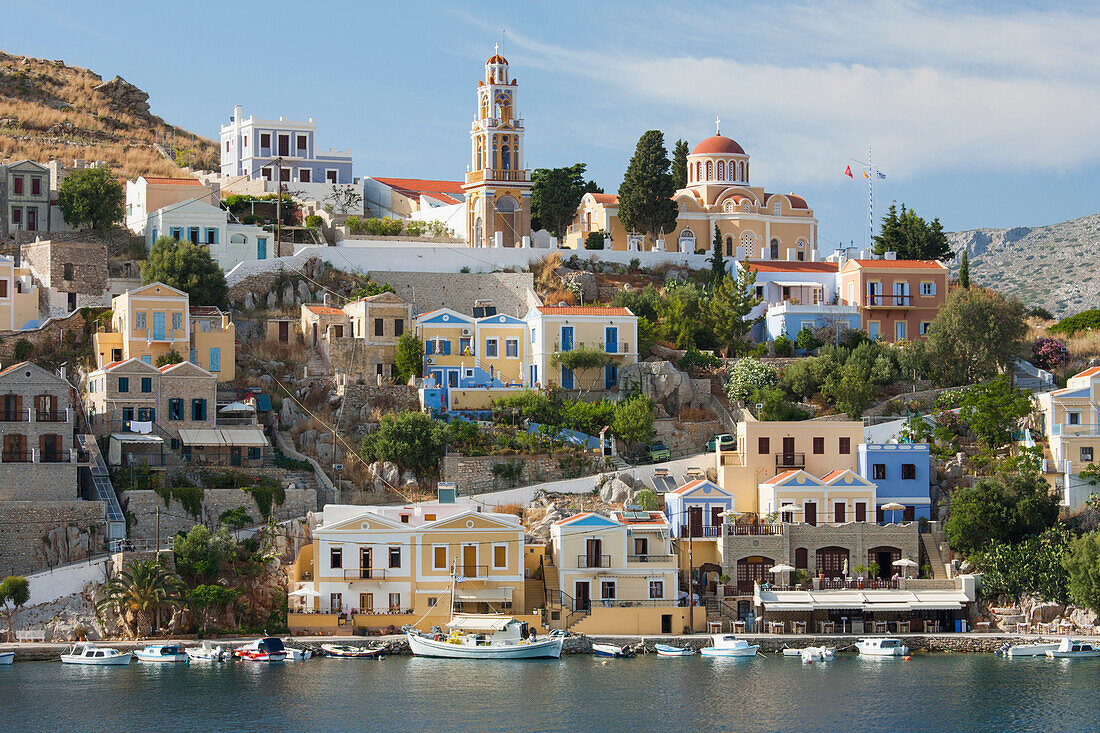 View over harbour to colourful houses and church, Gialos Yialos, Symi Simi, Rhodes, Dodecanese Islands, South Aegean, Greece, Europe