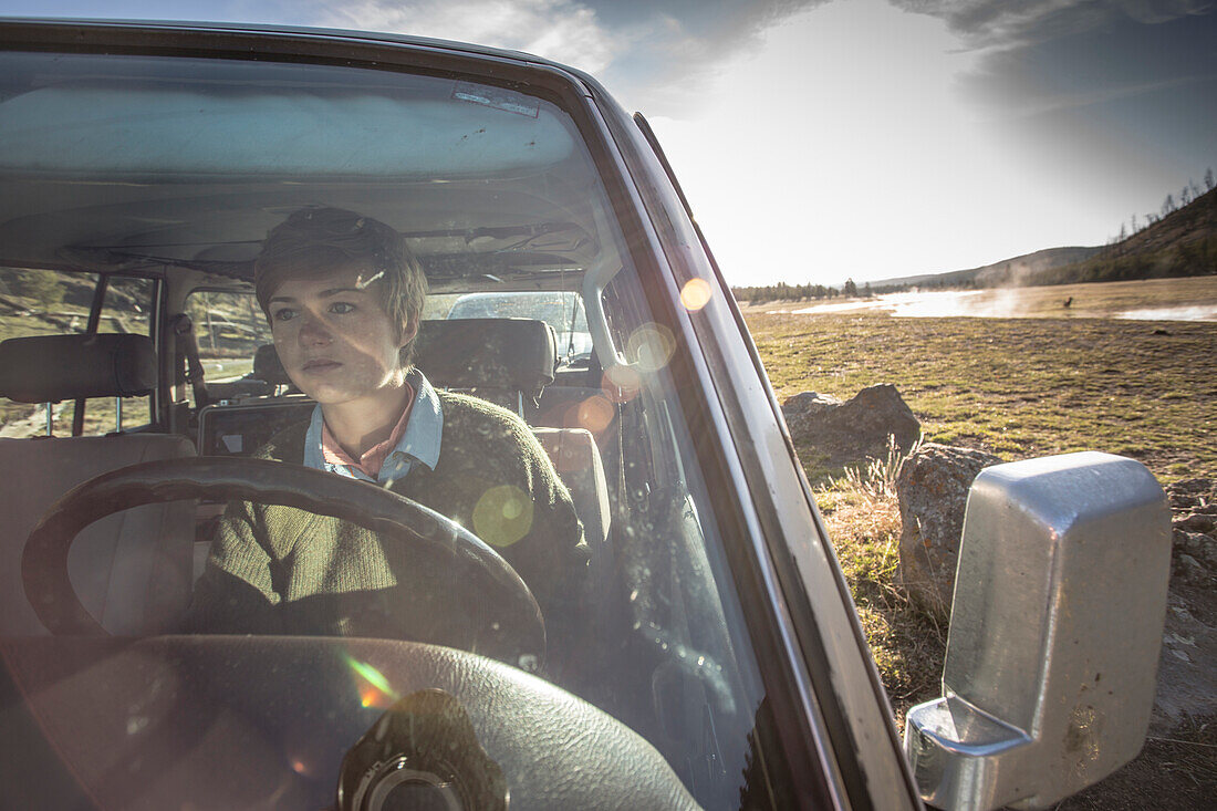 Girl drives a 1990 Land Cruiser across Yellowstone Country.