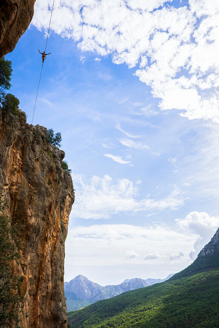 A man high lines high above the ground.