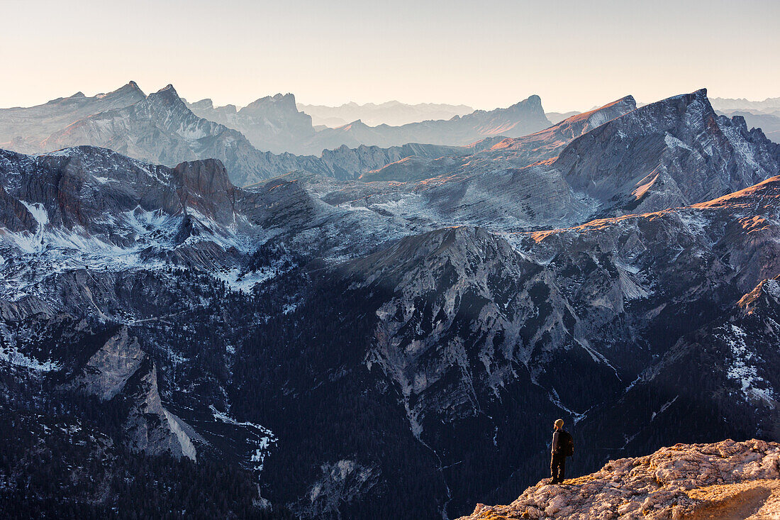 Hiker enjoying the panoramic view of the Dolomites, just before arriving at the top of Duerrenstein mountain, Unesco world heritage, Italy