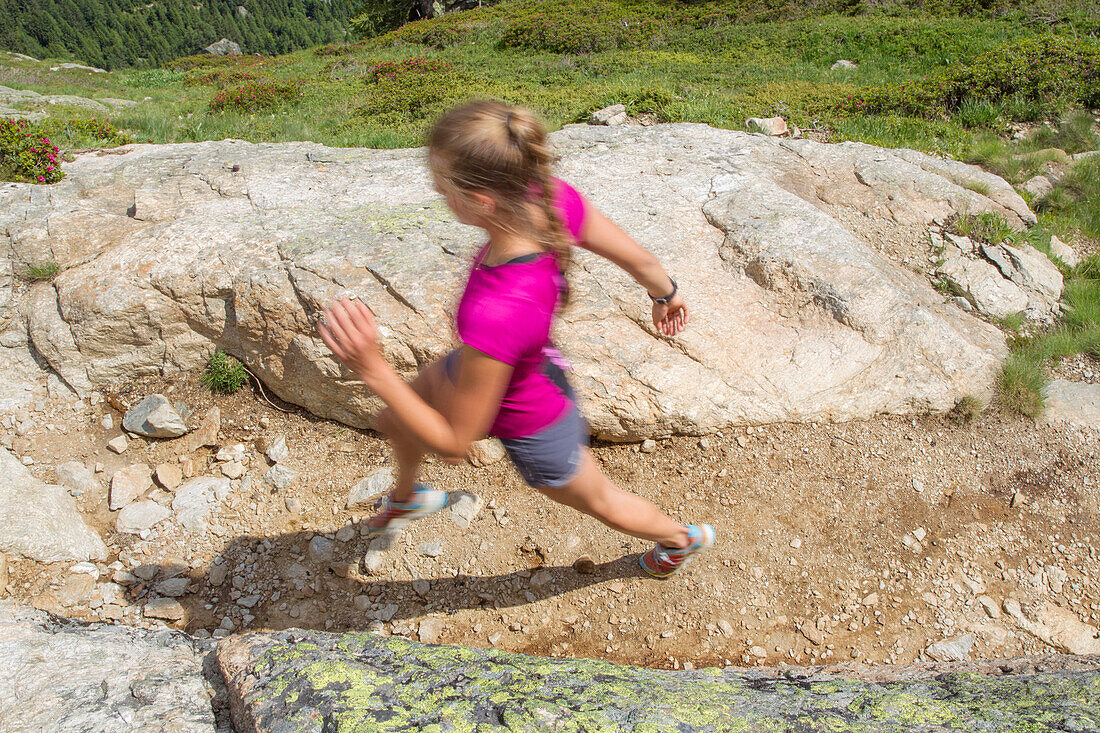 Girl trail running on a dried out path